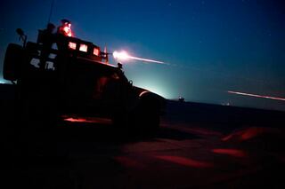 U.S. Marines fire an M240B from an MRAP All-Terrain Vehicle during night time machinegun range in Kuwait, June 16, 2020.