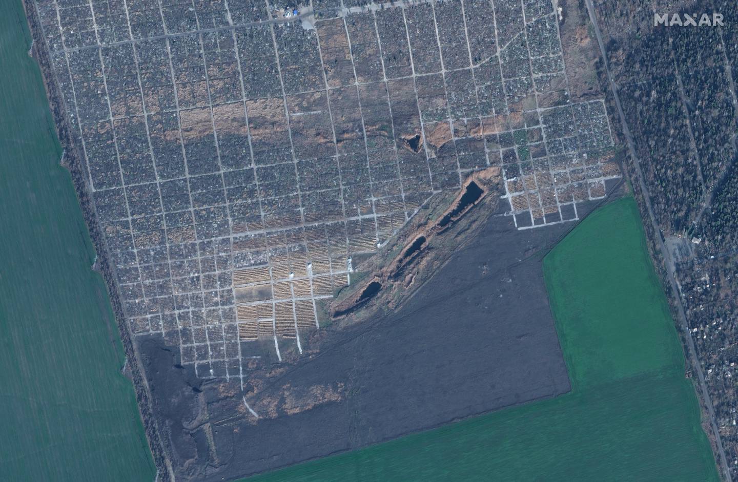 Satellite image shows new graves at a cemetery in Mariupol, Ukraine, Nov. 30, 2022.