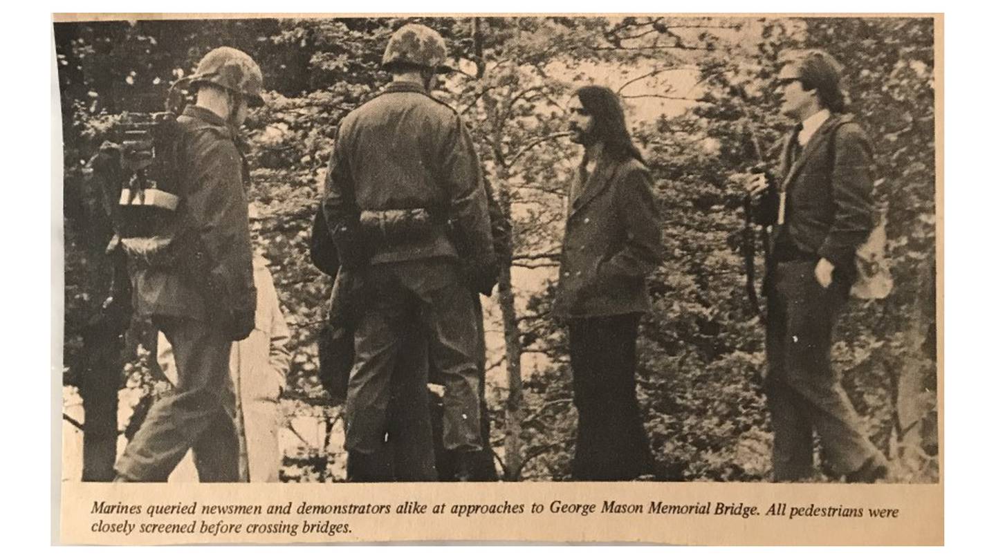 The Quantico Sentry newspaper caption reads: “Marines queried newsmen and demonstrators alike at approaches to George Mason Memorial Bridge.  All pedestrians were closely screened before crossing bridges.”