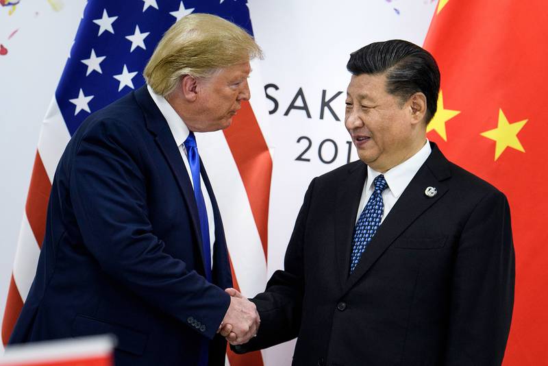 In this file photo taken June 28, 2019, China's President Xi Jinping, right, shakes hands with President Donald Trump before a bilateral meeting on the sidelines of the G20 Summit in Osaka.