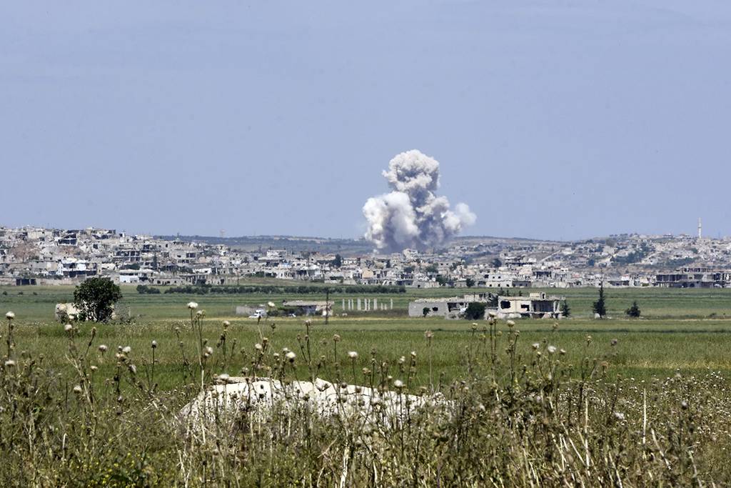Smoke billows from the town of Habeet after shelling by Syrian army forces from the adjacent town of Kafr Nabuda on May 11, 2019.