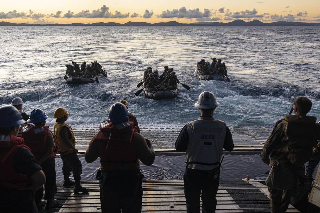 Marines paddle out during a boat raid debarkation aboard USS New Orleans in the Philippine Sea, Aug. 2, 2022.