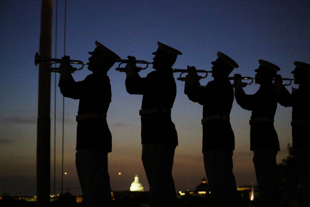 U.S. Marines with 'The Commandant’s Own' U.S. Marine Corps Drum & Bugle Corps play "Taps" during a Friday Evening Parade at Marine Barracks Washington D.C., May 25, 2018.