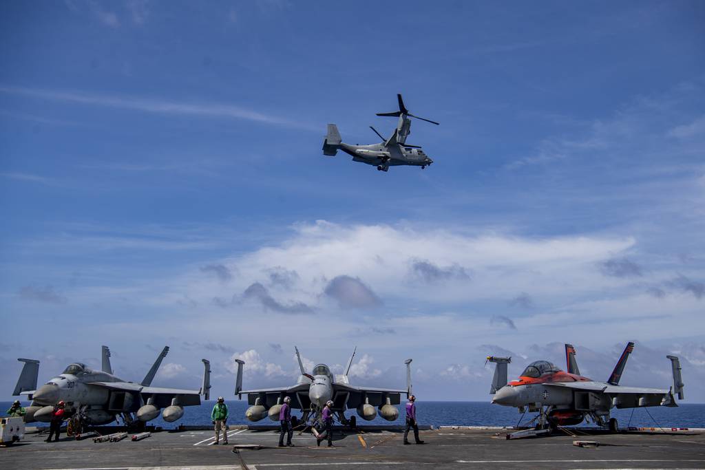 An MV-22 Osprey from the “Ugly Angels” of Marine Medium Tiltrotor Squadron 362 flies by the aircraft carrier Nimitz in the South China Sea, Feb. 11, 2023.