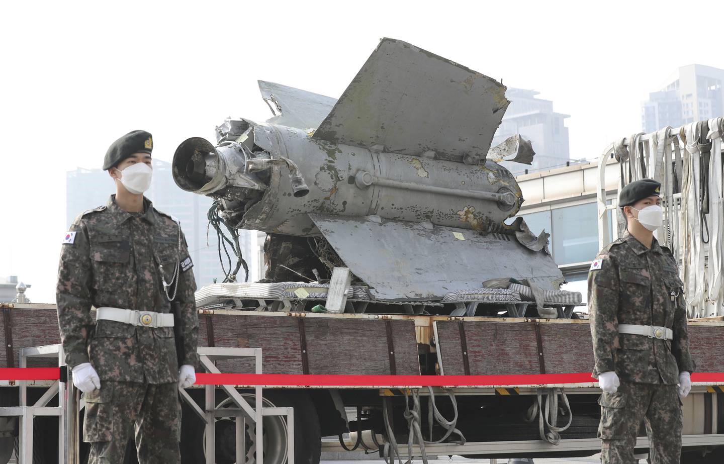South Korean army soldiers stand in front of the debris of a missile which the Defense Ministry identified as a North Korea's SA-5 surface-to-air missile according to South Korea's military, at the Defense Ministry in Seoul, South Korea, Wednesday, Nov. 9, 2022.