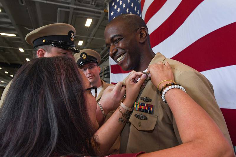 A senior chief machinist's mate (nuclear) is pinned during a pinning ceremony in the hangar bay aboard the Nimitz-class aircraft carrier USS Harry S. Truman (CVN 75), June 3, 2019, in Norfolk, Va.