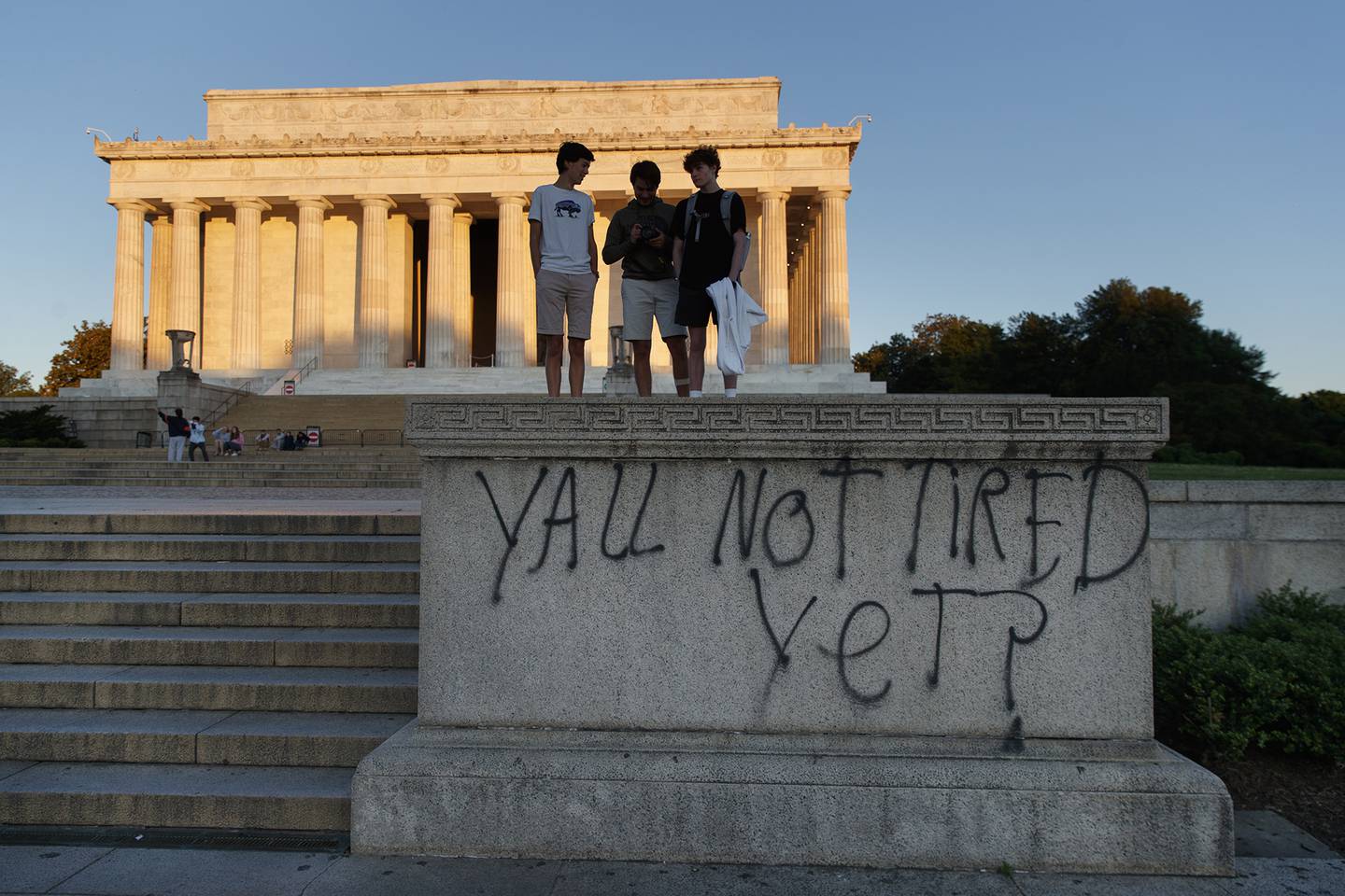 Spray paint that reads "Yall Not Tired Yet?" is seen on the base of the Lincoln Memorial on the National Mall in Washington, early Sunday, May 31, 2020, the morning after protests over the death of George Floyd.
