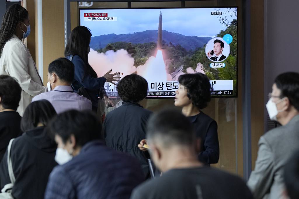People watch a news program showing a file image of a missile launch by North Korea at the Seoul Railway Station in Seoul, South Korea, Sunday, Sept. 25, 2022.