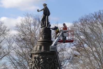 Workers prepare a Confederate memorial for removal in Arlington National Cemetery on Monday, Dec. 18, 2023 in Arlington, Va.