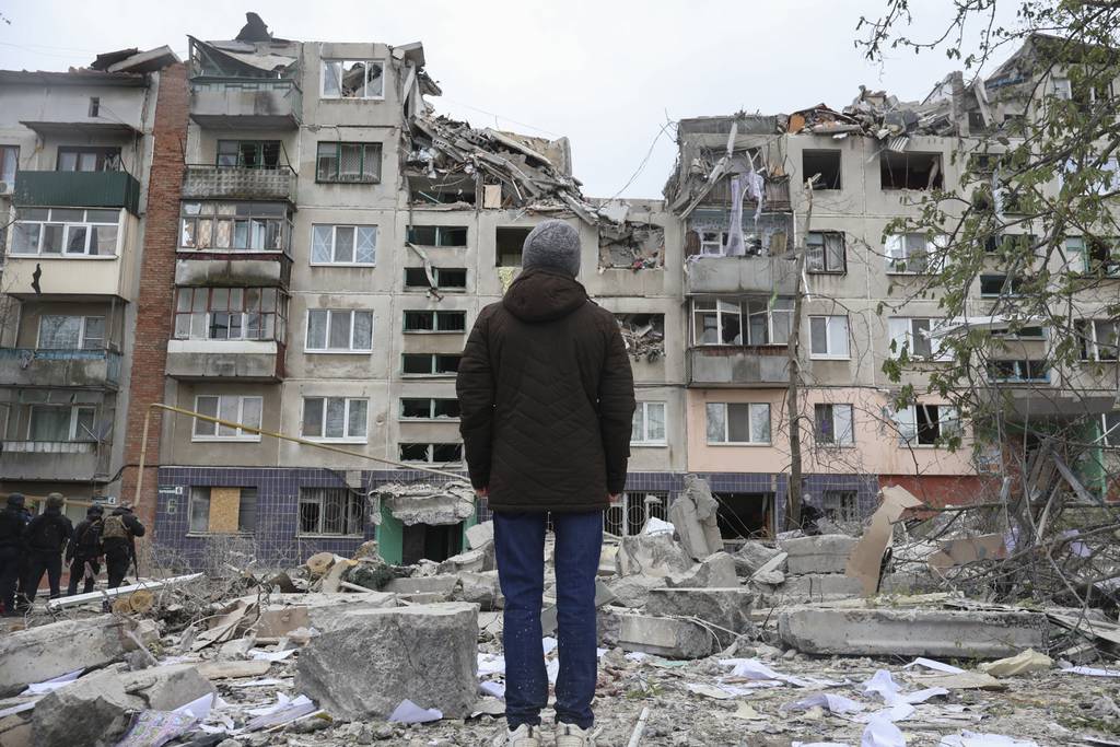 A local resident looks at his home, damaged by a Russian rocket attack in Sloviansk, Donetsk region, Ukraine, Friday, Apr. 14, 2023.
