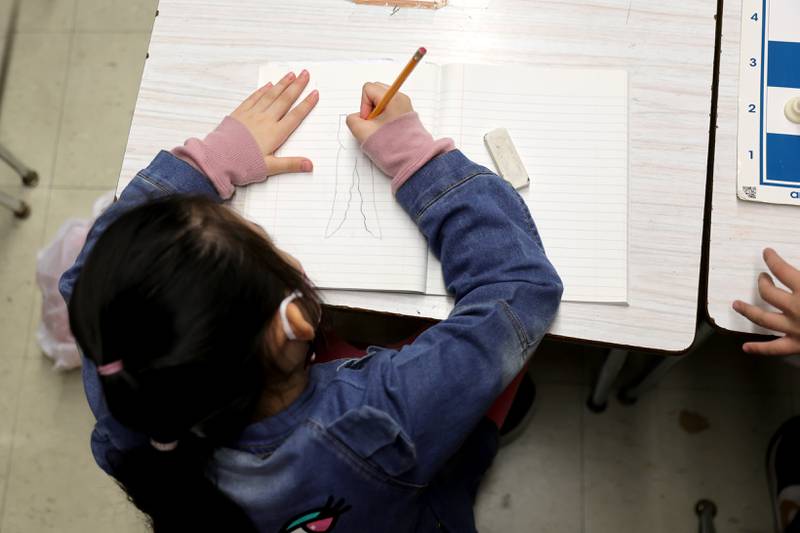 A student draws on a piece of paper during the second to last day of school as New York City public schools prepare to wrap up the 2021/2022 school year on June 24, 2022 in New York City.