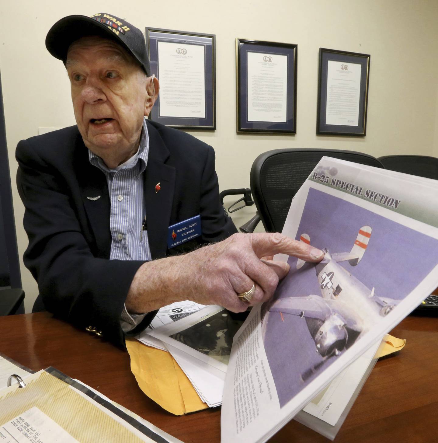 Former WWII POW Russell Scott points to the tail gunner position on a B25J during an interview at the Virginia War Memorial in Richmond, Va.