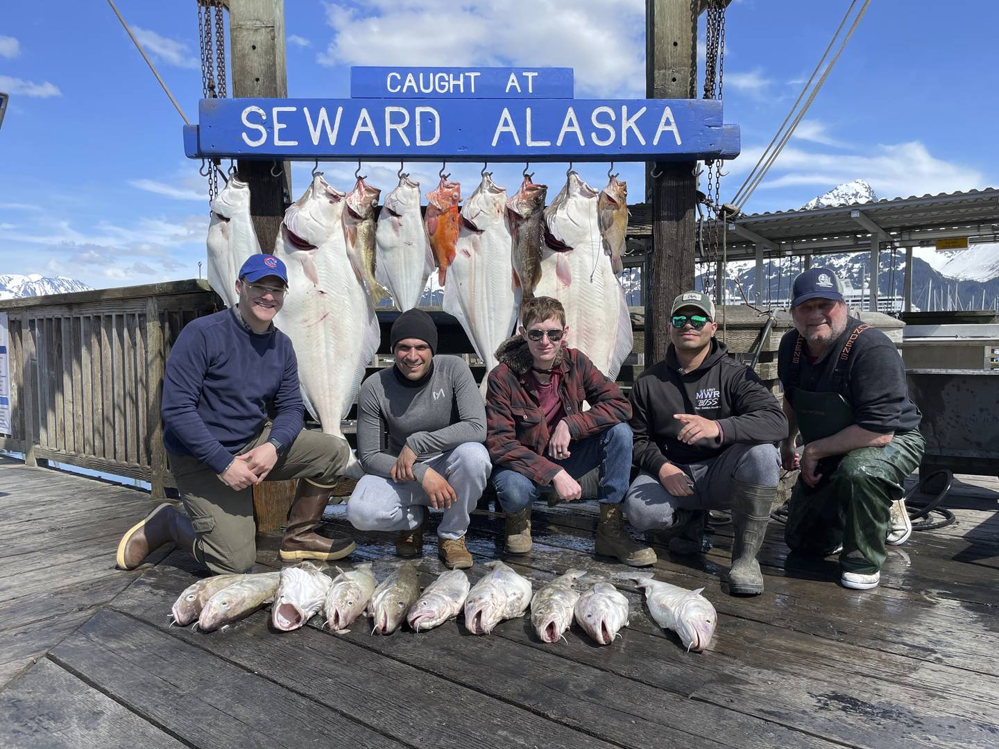 Captain John Moline, right, poses for a photo with others during the annual ASYMCA Alaska Combat Fishing Tournament on May 25, 2022, in Seward, Alaska.