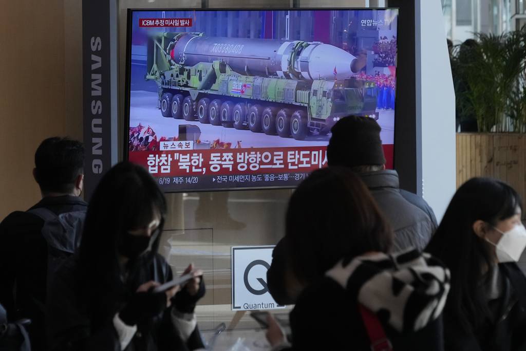 A TV screen shows a file image of North Korean missile in a military parade during a news program at the Seoul Railway Station in Seoul, South Korea, Friday, Nov. 18, 2022. South Korea says the missile North Korea launched Friday morning is likely an intercontinental ballistic missile.