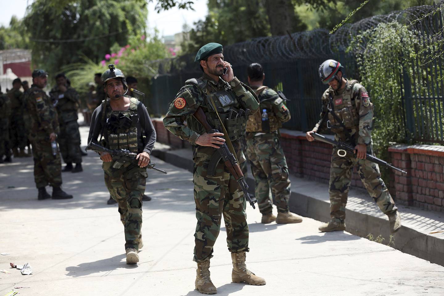 Afghan security personnel gather near a prison after an attack in the city of Jalalabad, east of Kabul, Afghanistan, Monday, Aug. 3, 2020.