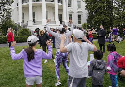 First lady Jill Biden walks though kids and families as they workout during the Joining Forces Military Kids Workout on the South Lawn of the White House in Washington, Saturday, April 29, 2023.