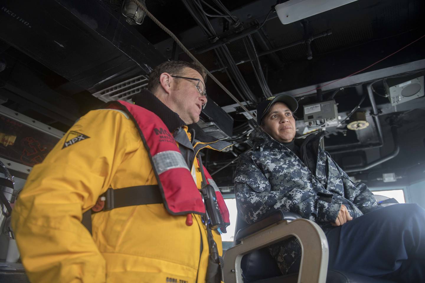 Capt. Shanti Sethi, commodore, commander, Task Force 64, right, observes with Angus Young as the Arleigh Burke-class guided-missile destroyer USS Winston S. Churchill gets underway Sept. 23, 2017.