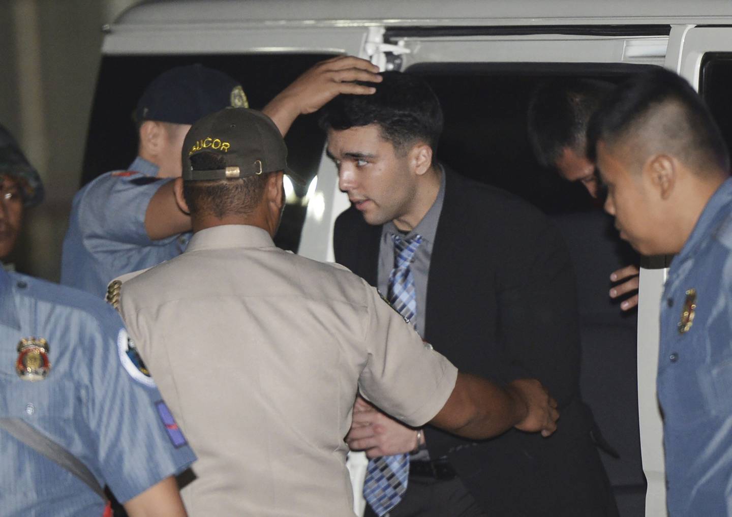 In this Dec. 1, 2015, file photo, convicted U.S. Marine Lance Cpl. Joseph Scott Pemberton is escorted to his detention cell upon arrival at Camp Aguinaldo at suburban Quezon city, northeast of Manila, Philippines.