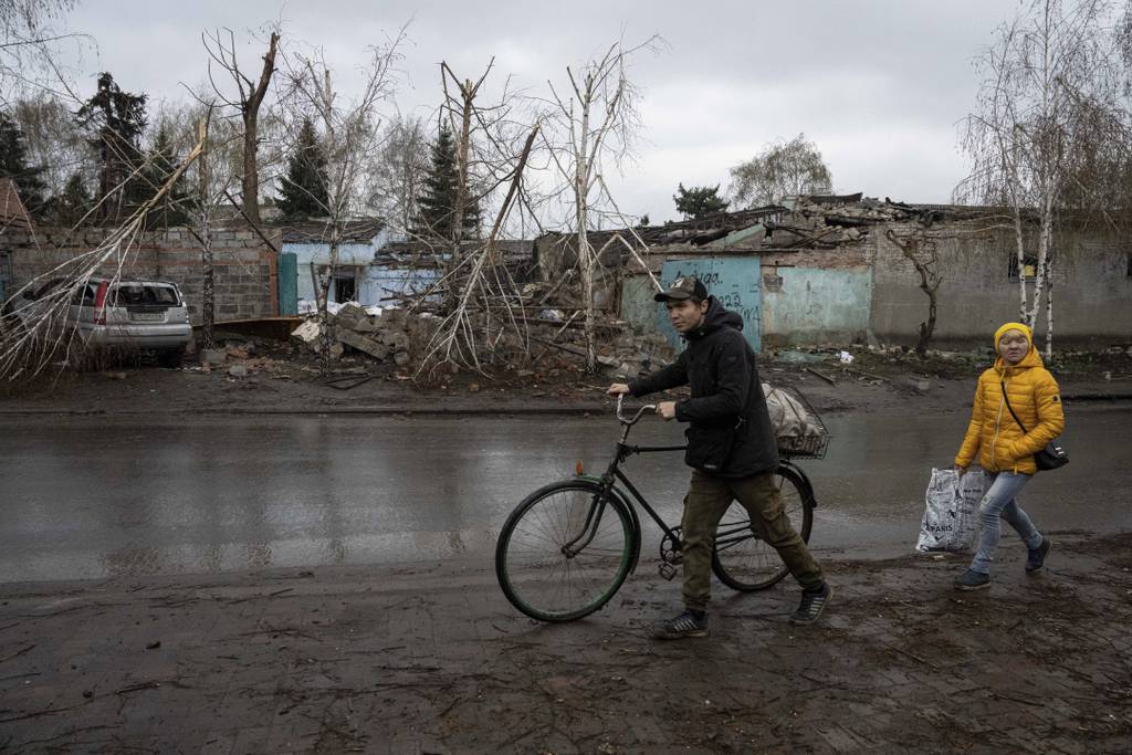 Locals walk past a house which was destroyed by Russian attack in Kostiantynivka, Ukraine, Thursday, April 6, 2023.
