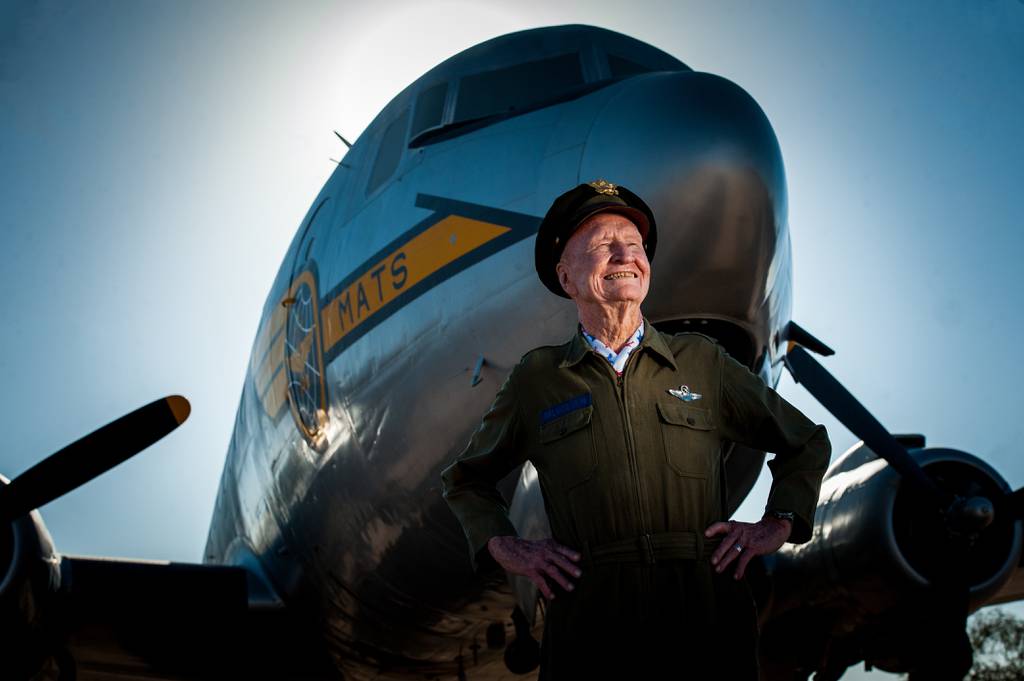 Retired Col. Gail S. Halvorsen, known commonly as the Berlin "Candy Bomber," stands in front of a C-54 Skymaster like the one he flew during WWII at the Pima Air and Space Museum in Arizona. Halvorsen dropped candy bars attached to parachutes made from handkerchiefs to German children watching the airlift operations from outside the fence of the Tempelhof Airport in West Berlin. (U.S. Air Force photo/Bennie J. Davis III)