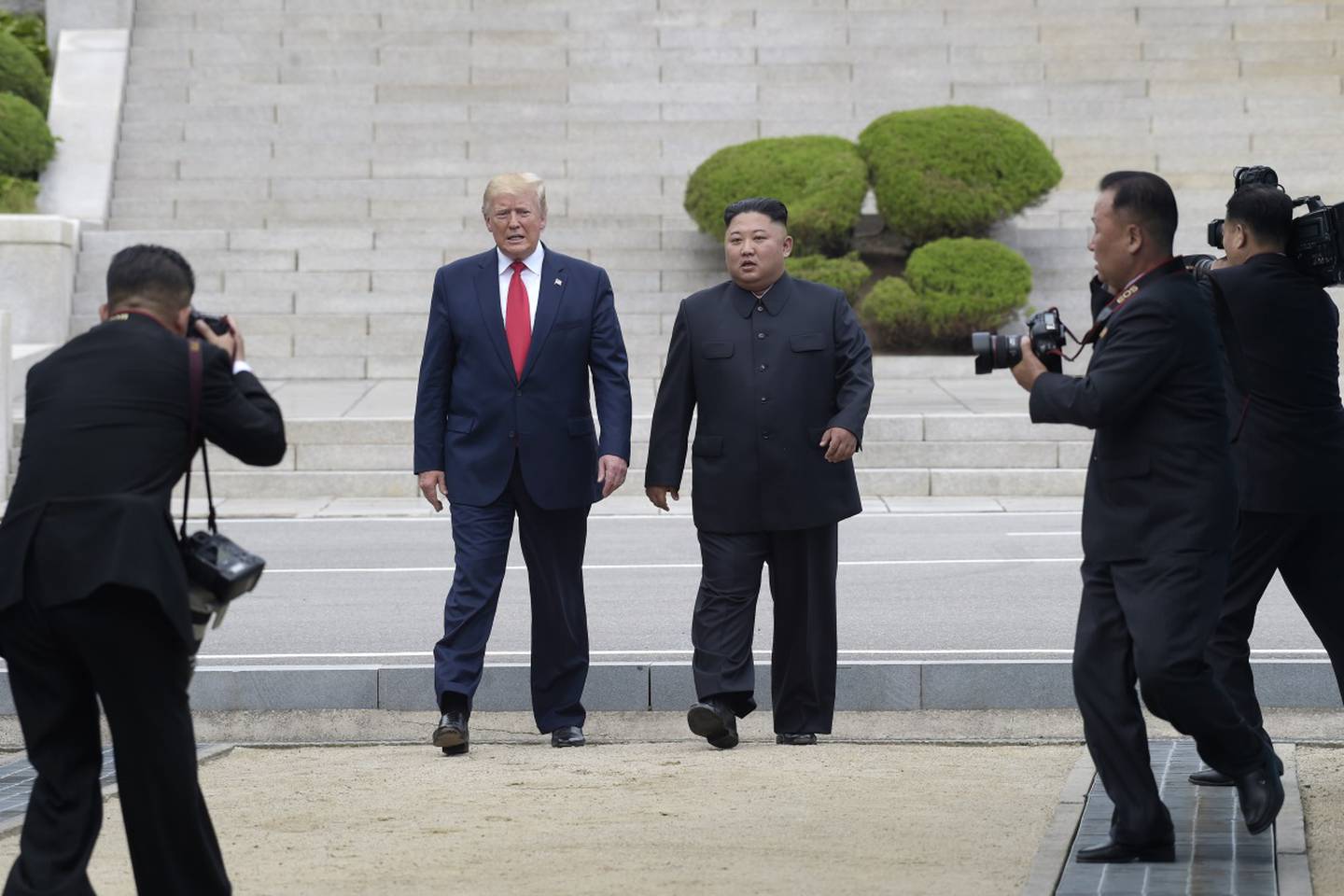 In this June 30, 2019, file photo, President Donald Trump, center left, and North Korean leader Kim Jong Un walk on the North Korean side at the border village of Panmunjom in the Demilitarized Zone.