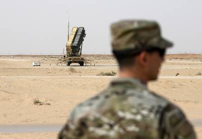 a member of the U.S. Air Force stands near a Patriot missile battery at the Prince Sultan air base in al-Kharj, central Saudi Arabia.