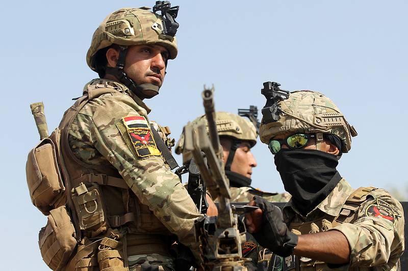 Iraqs rapid response forces storm a house in the Tarmiyah district, north of Baghdad, searching for wanted Islamic State group suspects on July 21, 2019.