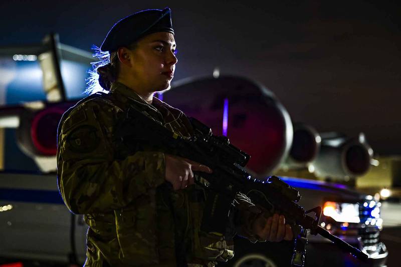 Senior Airman Alexis Williams, 911th Security Forces Squadron patrolman, stands guard in front of a C-17 Globemaster III during a routine training exercise at the Pittsburgh International Airport Air Reserve Station, Pa., Jan. 19, 2021.