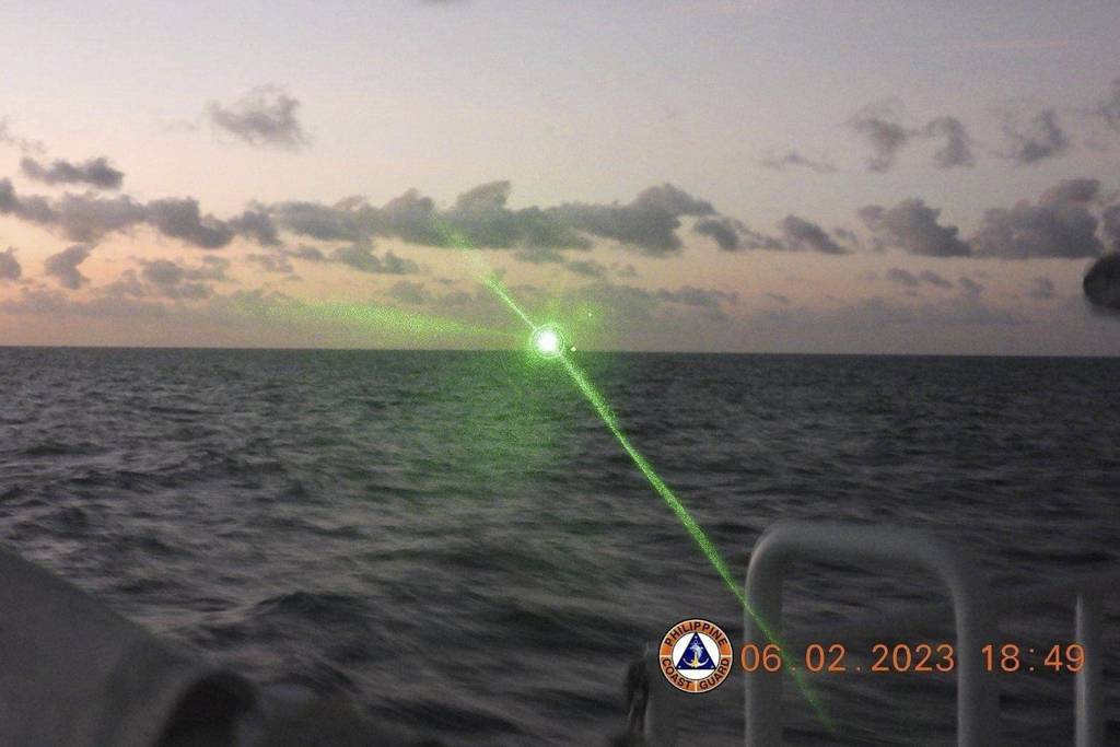This photo provided by the Philippine Coast Guard shows a green military-grade laser light from a Chinese coast guard ship in the disputed South China Sea on Feb. 6, 2023.