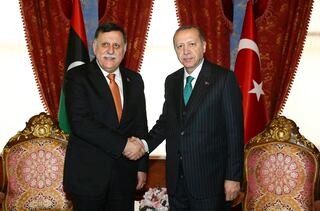 In this Feb. 26, 2018, file photo, Turkish President Recep Tayyip Erdogan, right, shakes hands with Fayez al-Sarraj, the chairman of the Libyan Presidential Council, shortly before departing for a five-day African tour, in Istanbul.