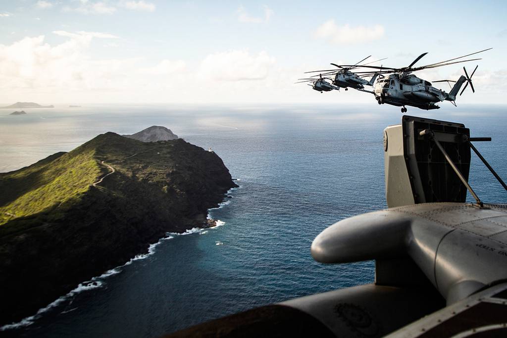 Marines fly near the shores of Kalaeuila in CH-53E Super Stallion helicopters over the Island of Oahu, Hawaii, on July 3, 2019.