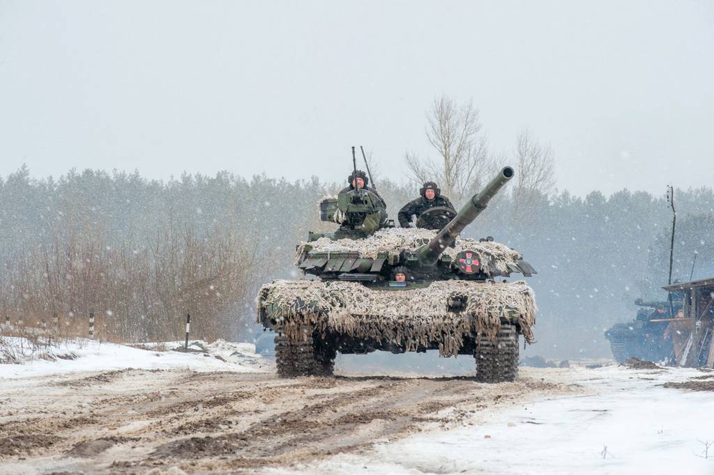 Ukrainian troops use tanks, self-propelled guns and other armored vehicles to conduct live-fire exercises near the town of Chuguev, in the Kharkiv region, on Feb. 10, 2022.