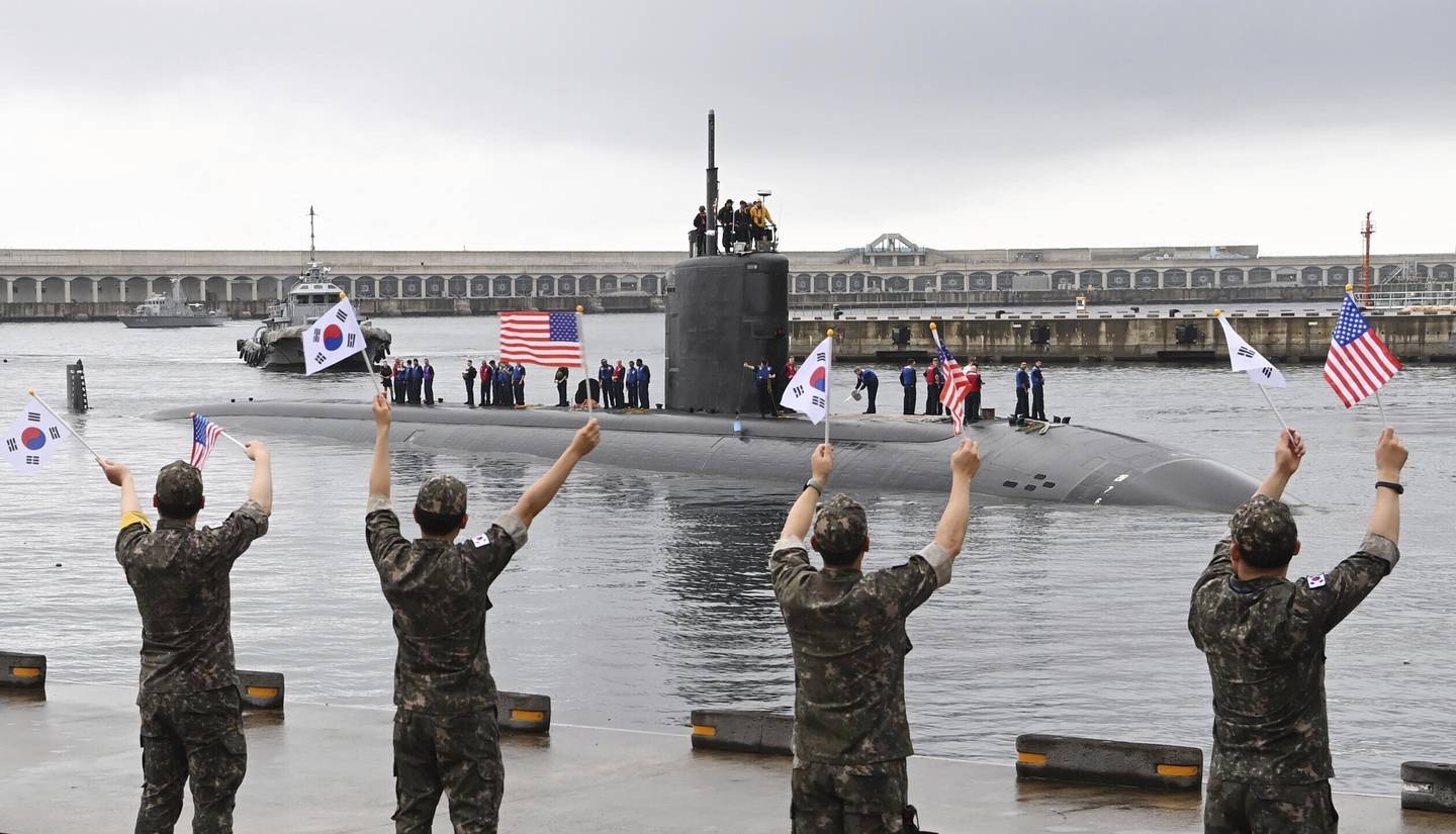 In this photo provided by South Korea Defense Ministry, South Korean navy sailors wave as the U.S. nuclear-powered submarine Annapolis arrives at a South Korean naval base on Jeju Island, South Korea, Monday, July 24, 2023.
