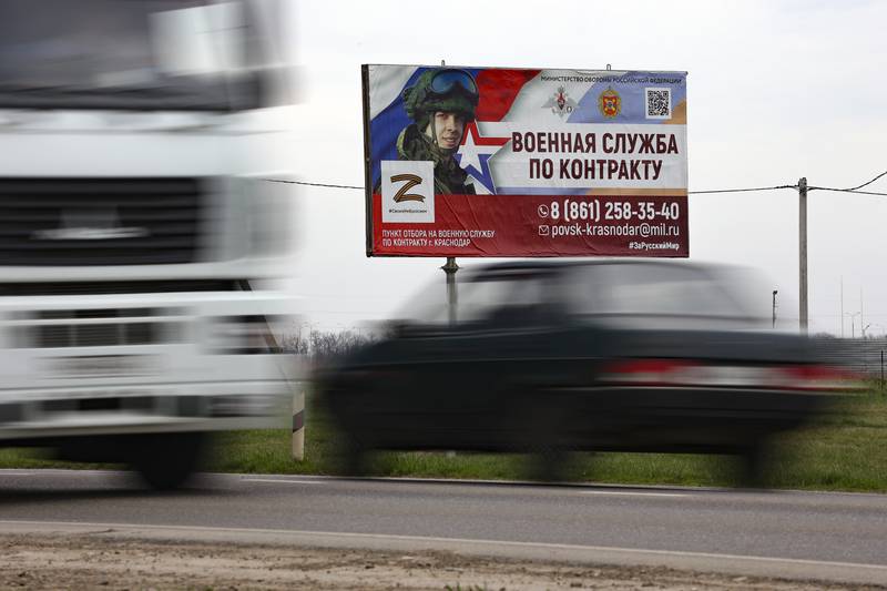A billboard advertising "Contract military service" is seen beside a highway outside Krasnodar, Russia, Thursday, March 23, 2023.