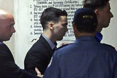 In this Dec. 1, 2015 file photo, U.S. Marine Lance Cpl. Joseph Scott Pemberton, center, is escorted as he arrives at court before his conviction of homicide for killing Filipino transgender Jennifer Laude in Olongapo city, Zambales province, northwest of Manila, Philippines.