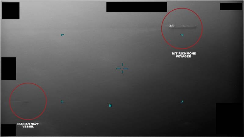This screenshot of a video, released by the U.S. Navy, shows an Iranian navy vessel near commercial tanker Richmond Voyager in the Gulf of Oman, July 5, 2023.