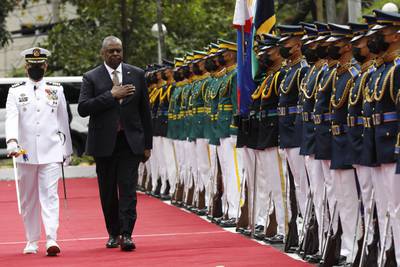 U.S. Defense Secretary Lloyd Austin, second from left, walks past military guards during his arrival at the Department of National Defense in Camp Aguinaldo military camp in Quezon City, Metro Manila, Philippines on Thursday February 2, 2023.