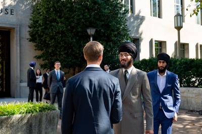 Aekash Singh and Milaap Singh Chahal, two young men wearing suits, stand outside of the D.C. Circuit Court of Appeals in October.