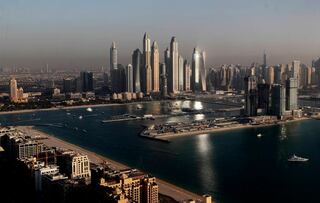 Luxury towers dominate the skyline in the Marina district, center, and the new Dubai Harbour development, right, are seen from the observation deck of "The View at The Palm Jumeirah" in Dubai, United Arab Emirates, April 6, 2021.