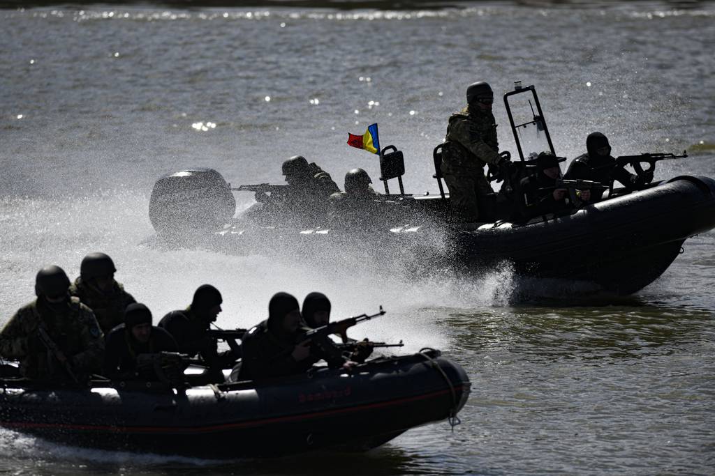 Romanian naval commandos sail in speedboats on the river Danube during a Romanian Navy led exercise outside Mahmudia, Romania, Thursday, March 30, 2023.