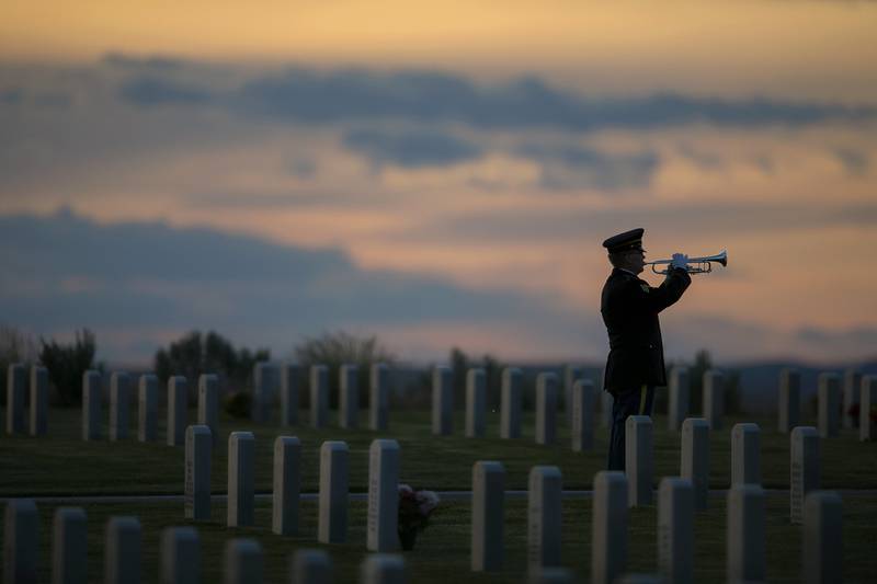 Idaho Army National Guard Staff Sgt. Michael Robinett plays "Taps" at the Idaho State Veterans Cemetery that overlooks Boise, Idaho.