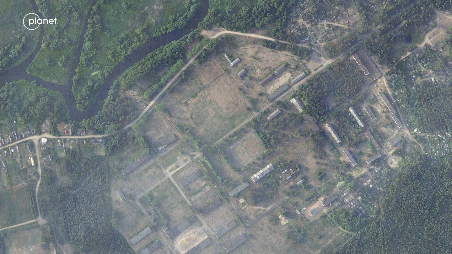 This satellite image provided by Planet Labs PBC taken on Thursday, June 15, 2023, shows a former military base outside the Belarusian town of Osipovichi shows no signs of the structures that appeared two weeks later.