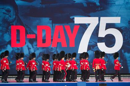 An honor guard marches on stage during a ceremony to mark the 75th Anniversary of D-Day,