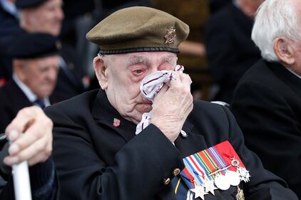 A veteran wipes his eyes during a ceremony to mark the 75th anniversary of D-Day
