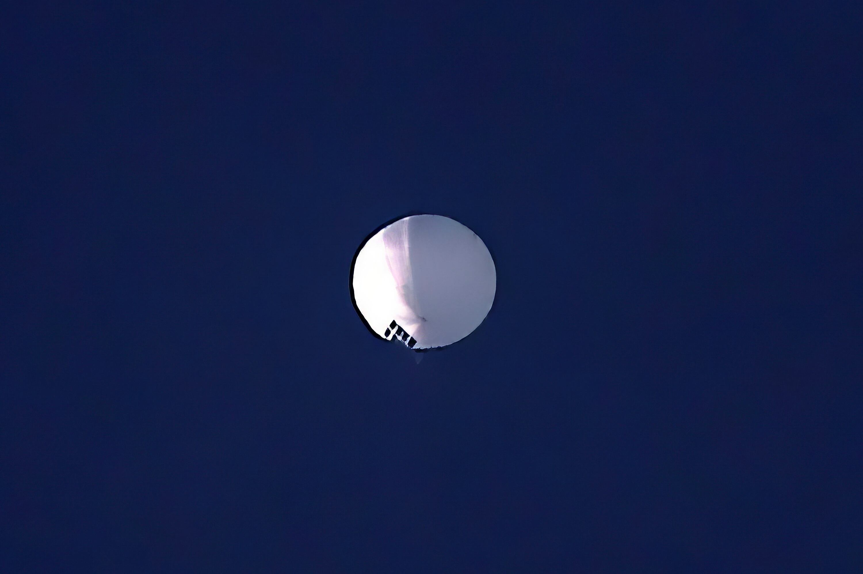 A high altitude balloon floats over Billings, Mont., on Wednesday, Feb. 1, 2023. The huge, high-altitude Chinese balloon sailed across the U.S. on Friday, drawing severe Pentagon accusations of spying and sending excited or alarmed Americans outside with binoculars.