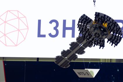 L3Harris Technologies slings a model of the Navigation Technology Satellite-3, or NTS-3, from the ceiling at the Sea-Air-Space conference in National Harbor, Maryland, in April 2023.