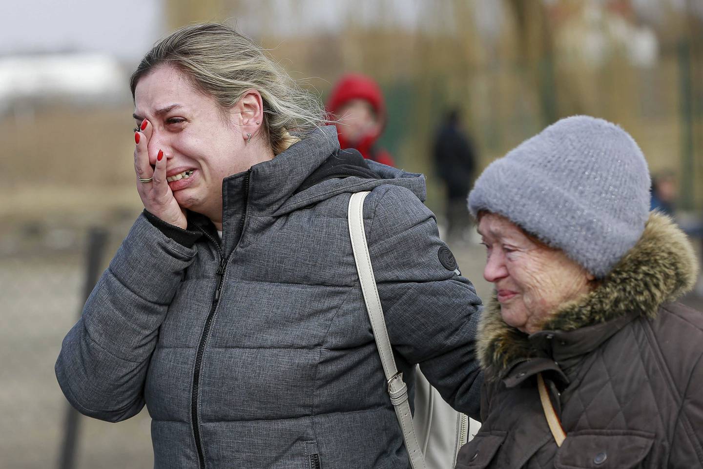 A Ukrainian woman reacts after arriving at the Medyka border crossing, in Poland, Sunday, Feb. 27, 2022. Since Russia launched its offensive on Ukraine, more than 200,000 people have been forced to flee the country to bordering nations like Romania, Poland, Hungary, Moldova, and the Czech Republic — in what the U.N. refugee agency, UNHCR, said will have "devastating humanitarian consequences" on civilians. (AP Photo/Visar Kryeziu)